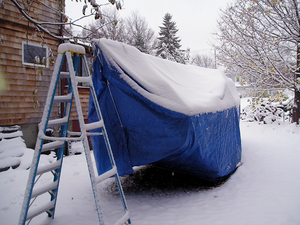 Tarpaulin cover boat in the snow